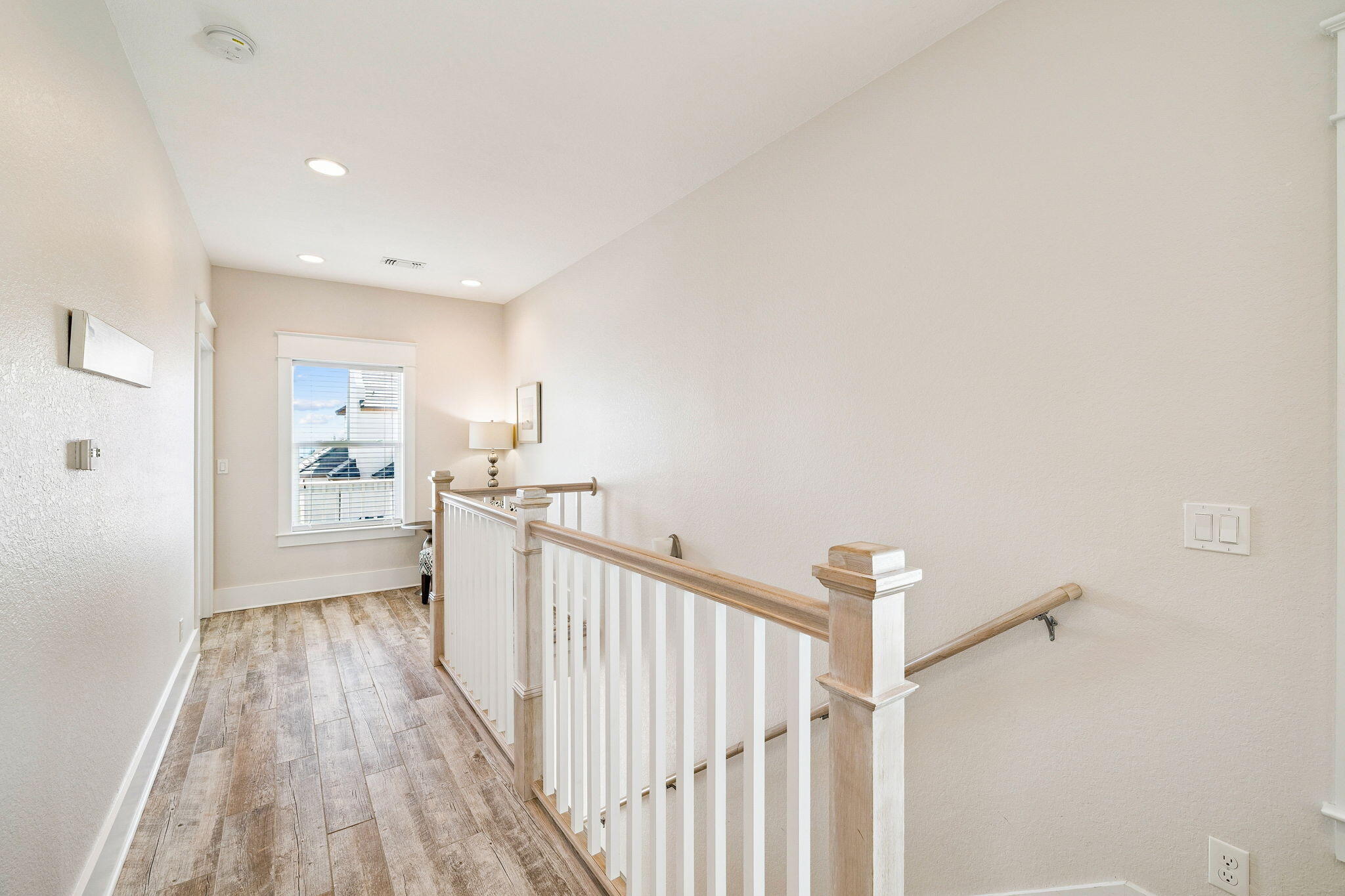 32 Moonlit Shores Lane Santa Rosa Beach, FL 32459 - Photo 36 of 48 a view of a hallway with wooden floor and staircase