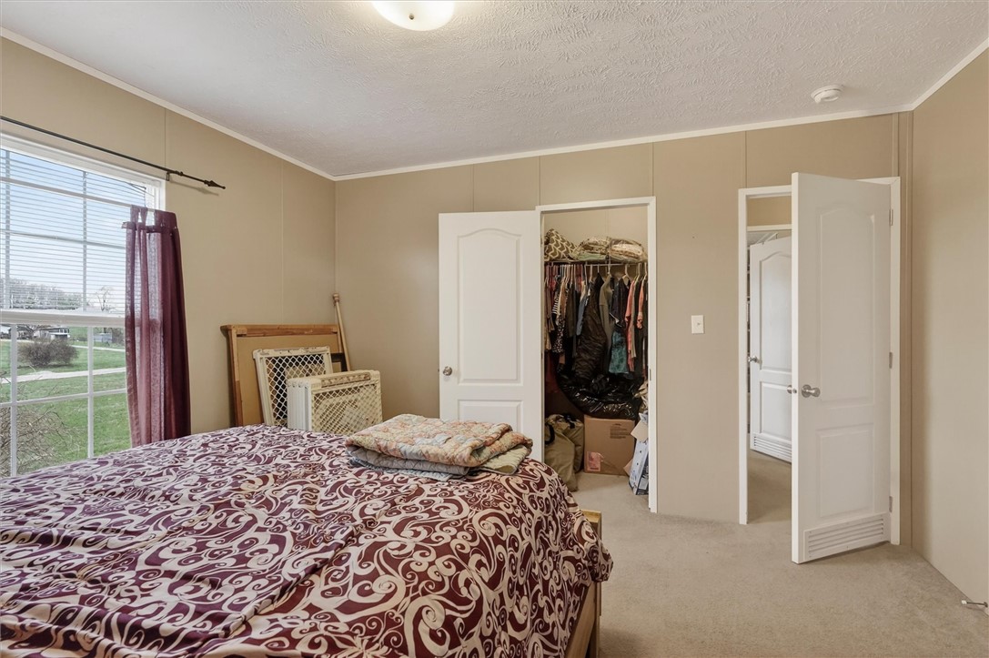 1926 Fairview Road Peebles, OH 45660 - Photo 34 of 44 This spacious bedroom offers ample storage and abundant natural light.