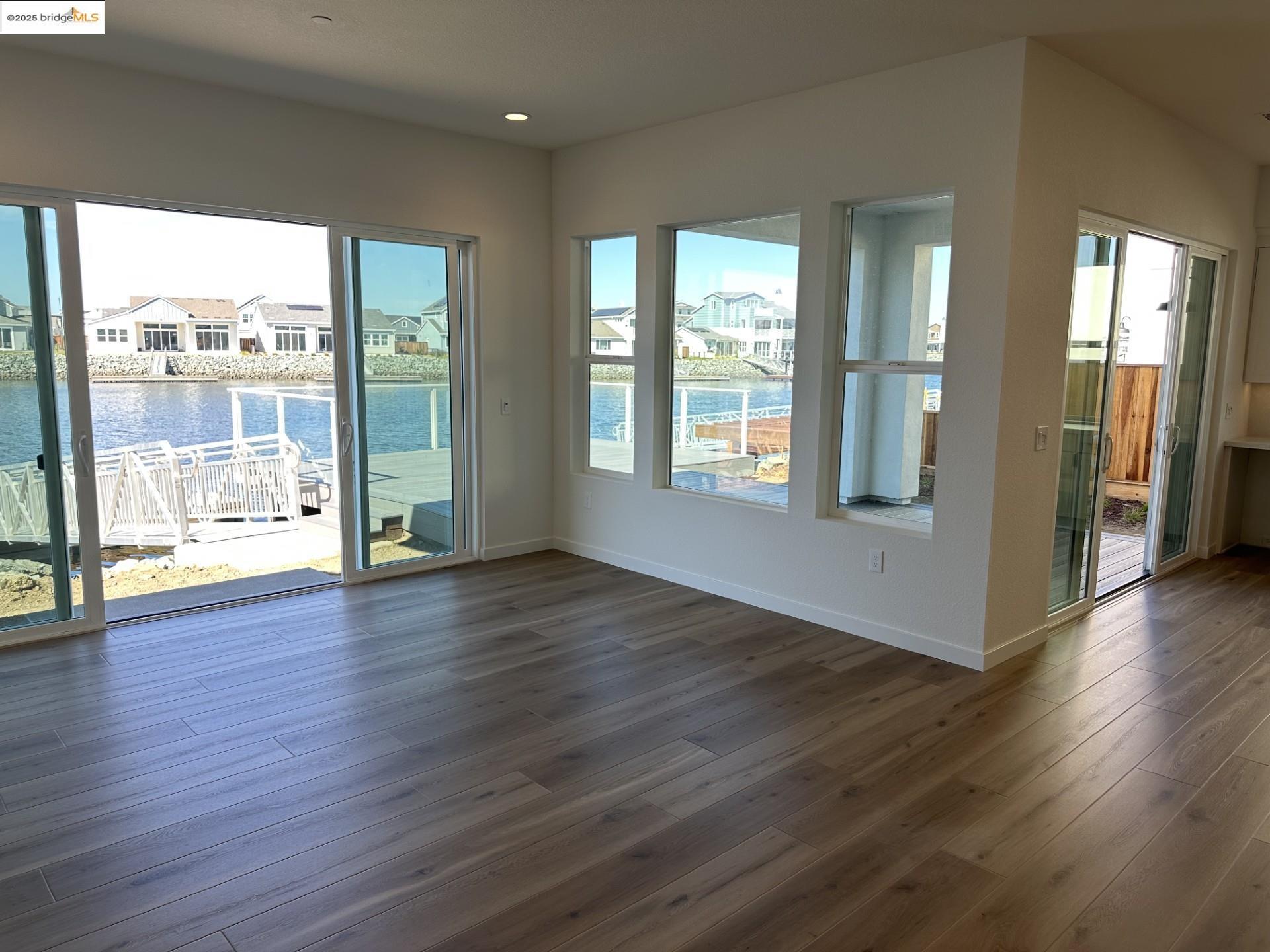 667 Point Place Bethel Island, CA 94511 - Photo 26 of 27 a view of an empty room with wooden floor and a window