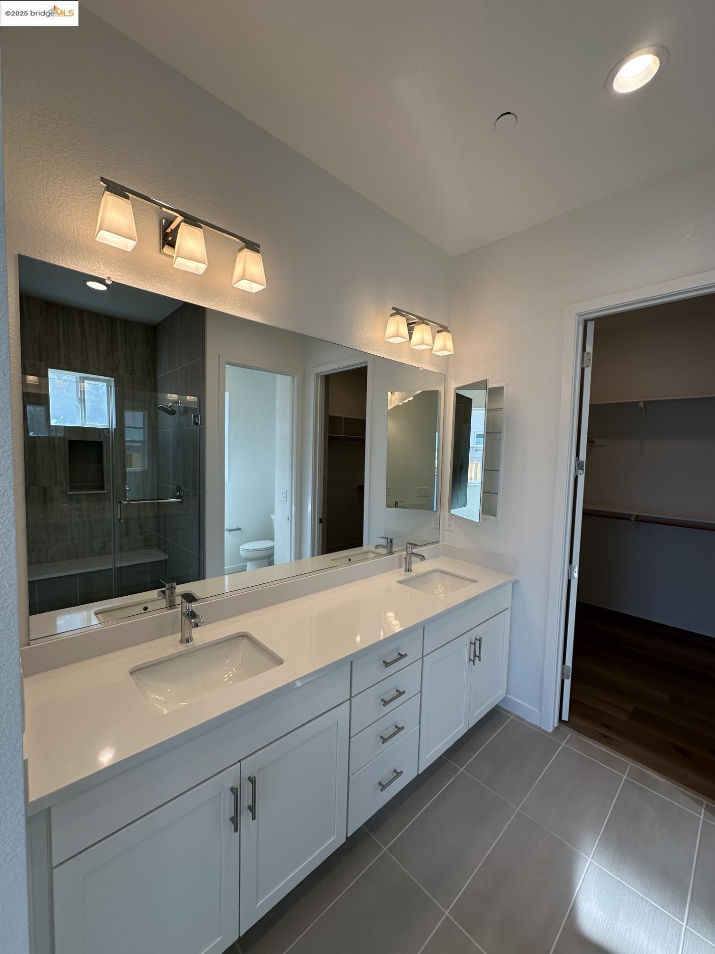 667 Point Place Bethel Island, CA 94511 - Photo 12 of 27 a spacious bathroom with a double vanity sink and a mirror