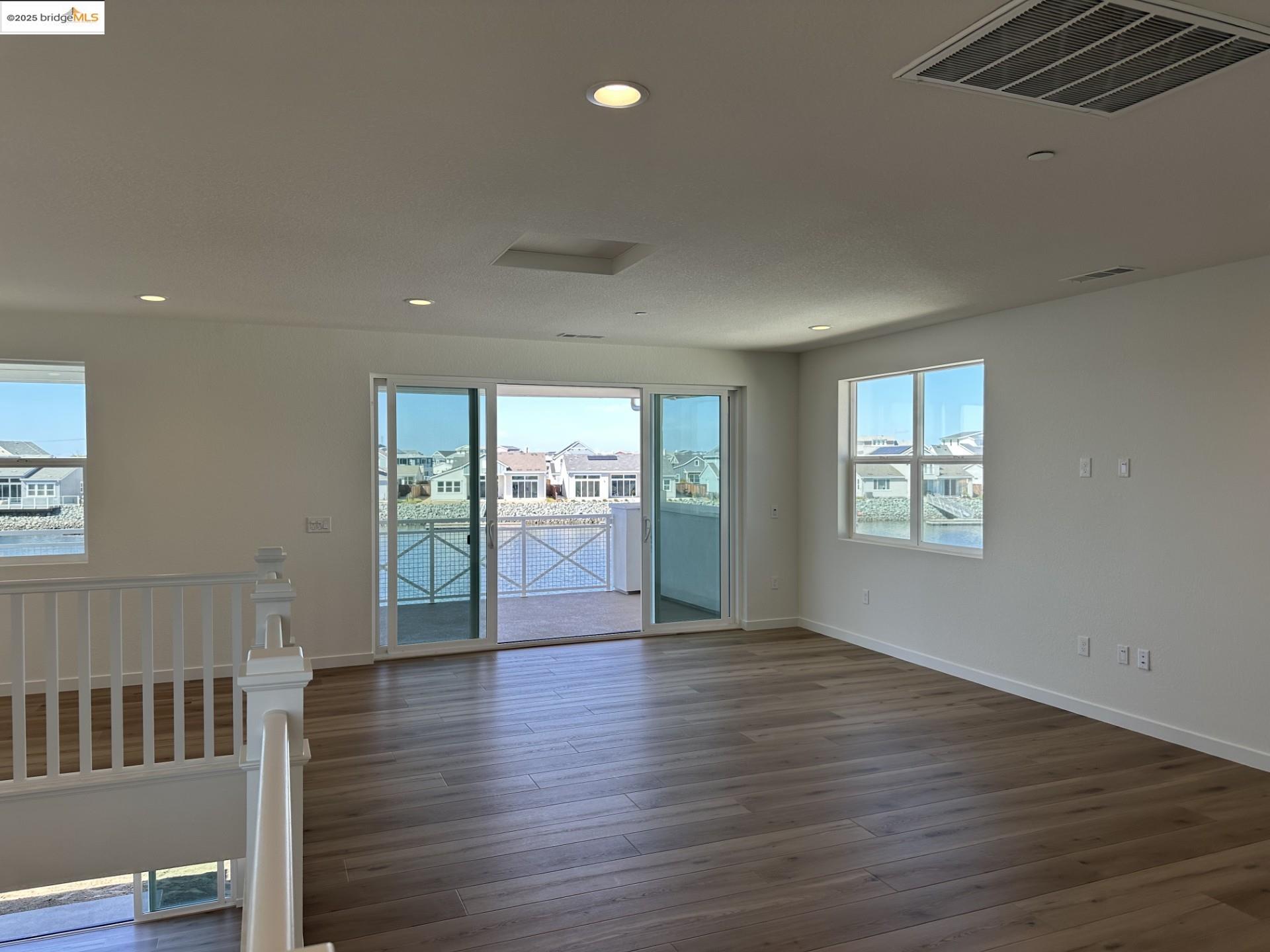 667 Point Place Bethel Island, CA 94511 - Photo 15 of 27 a view of an empty room with wooden floor and a window