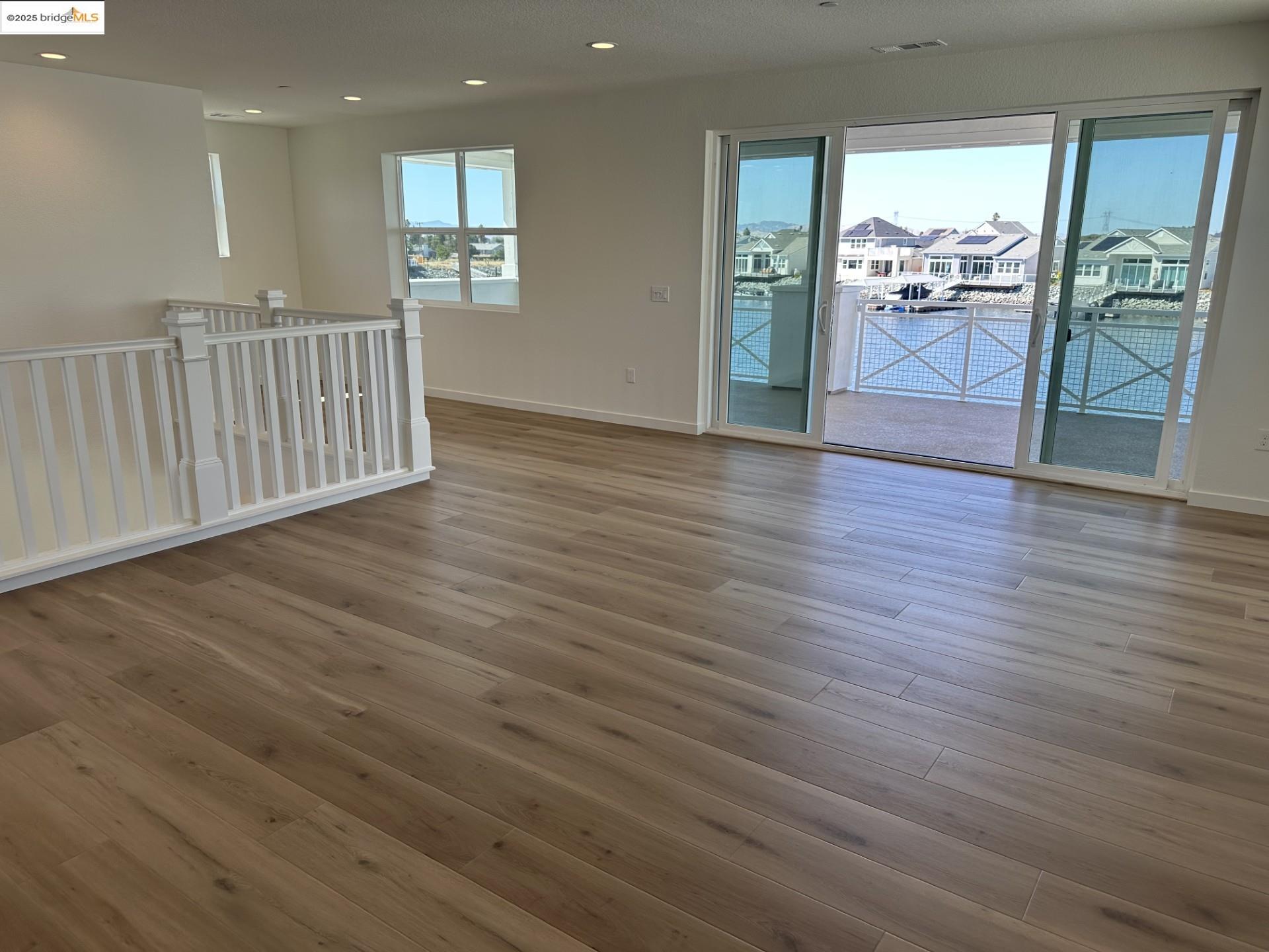 667 Point Place Bethel Island, CA 94511 - Photo 16 of 27 an empty room with wooden floor and entrance