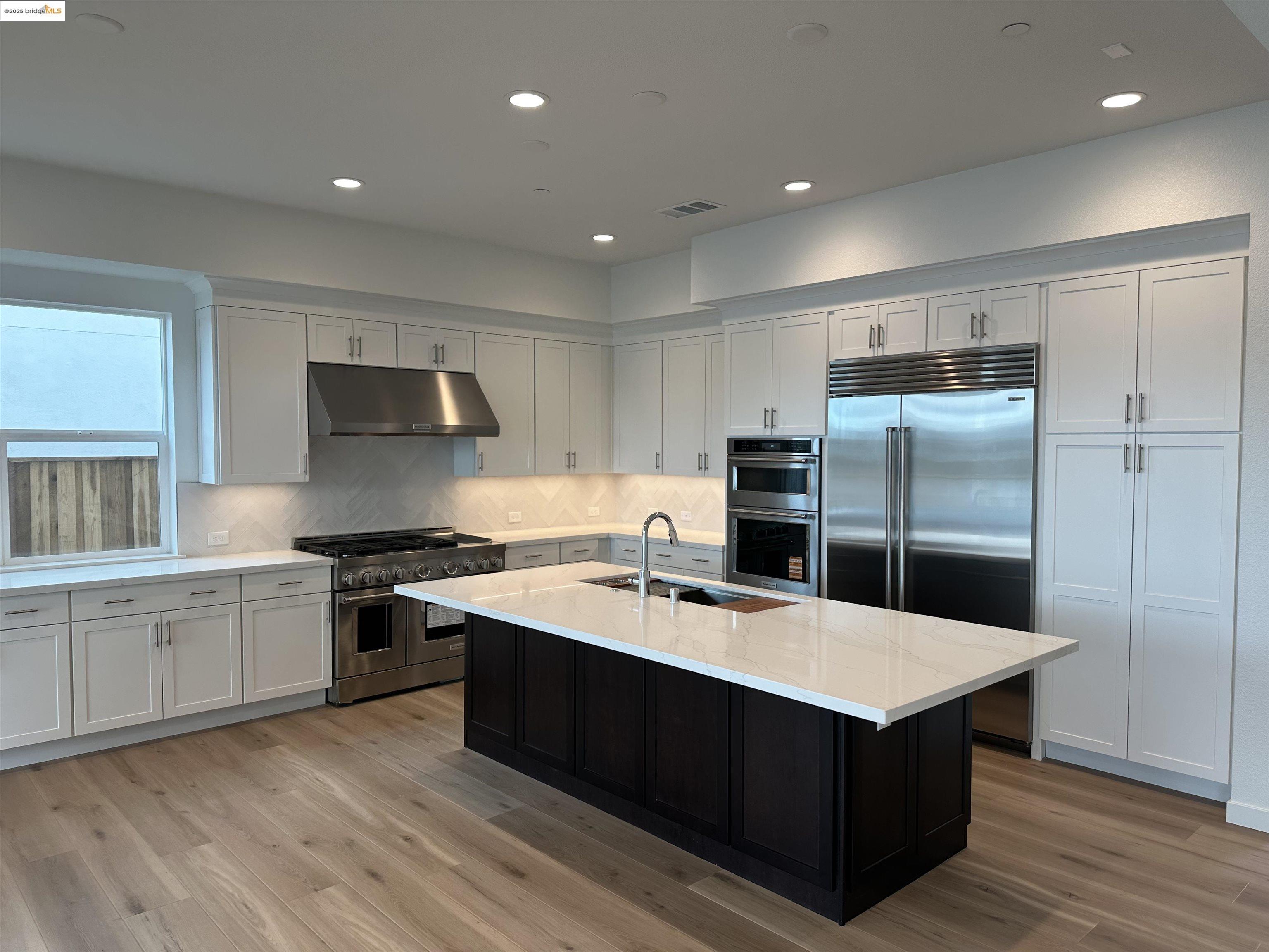 667 Point Place Bethel Island, CA 94511 - Photo 4 of 27 a kitchen with stainless steel appliances a sink stove and refrigerator