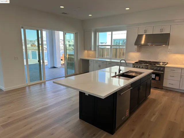 a stove top oven sitting inside of a kitchen