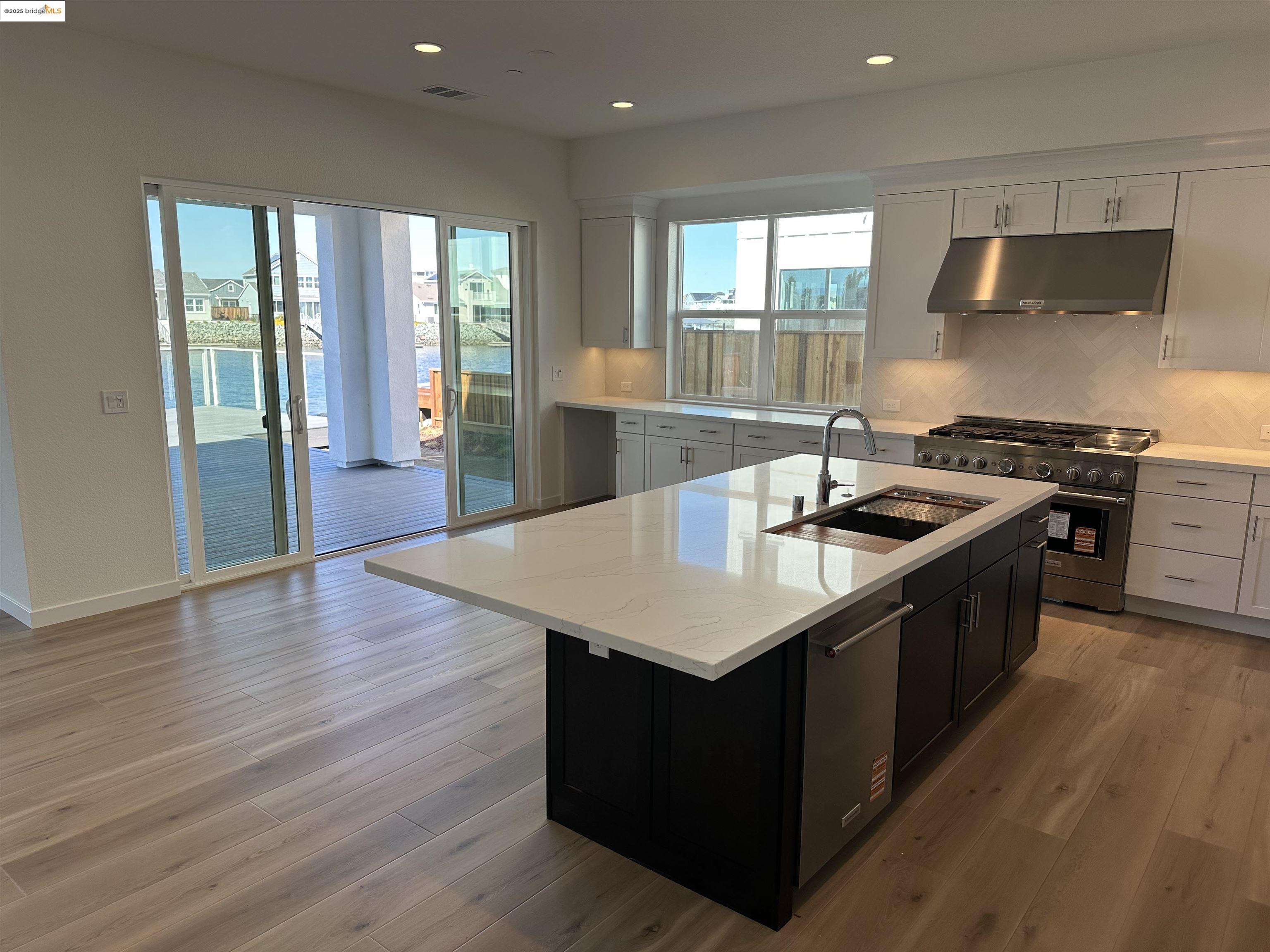667 Point Place Bethel Island, CA 94511 - Photo 5 of 27 a kitchen with granite countertop a sink a counter top space and stainless steel appliances