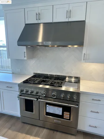 a kitchen with a sink and a stove top oven