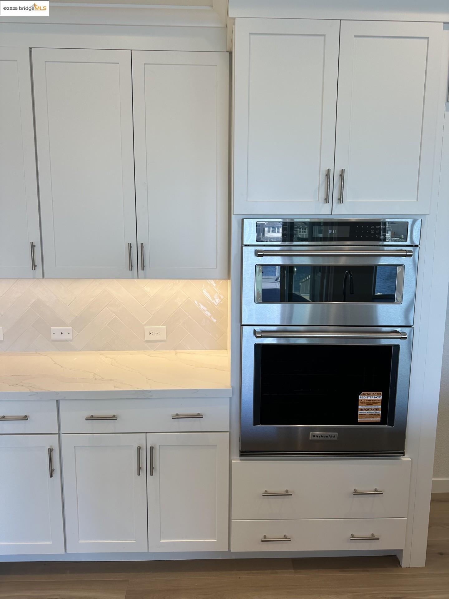 667 Point Place Bethel Island, CA 94511 - Photo 8 of 27 a kitchen with white cabinets and black appliances
