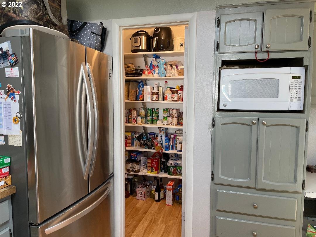 449 East 4th Avenue Riddle, OR 97469 - Photo 5 of 17 a view of a refrigerator and cabinets