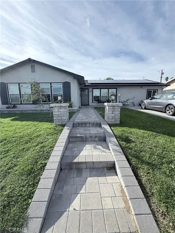a front view of a house with garden