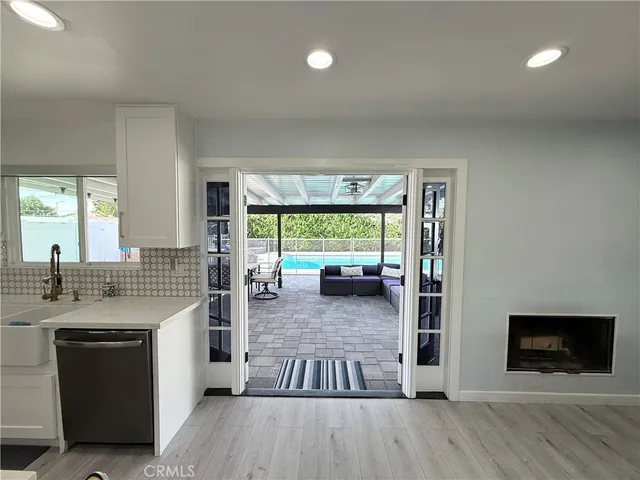 a kitchen with a stove and a wooden floor
