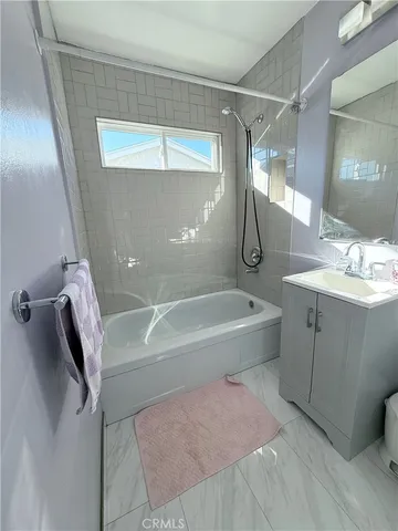a spacious bathroom with a granite countertop sink a toilet and shower