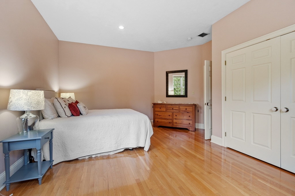 98 Fox Run Road Bolton, MA 01740 - Photo 22 of 42 a bedroom with a bed and wooden floor