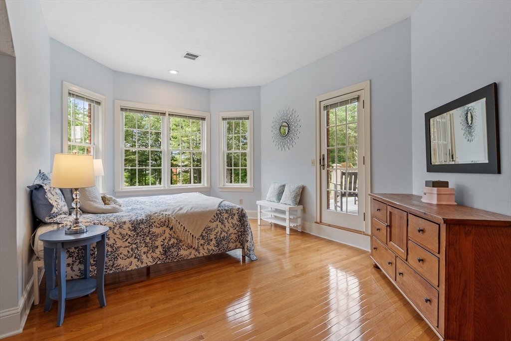 98 Fox Run Road Bolton, MA 01740 - Photo 23 of 42 a bedroom with a bed and wooden floor
