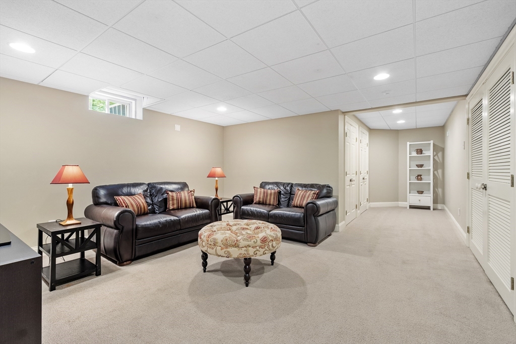 98 Fox Run Road Bolton, MA 01740 - Photo 32 of 42 a living room with furniture and a lamp