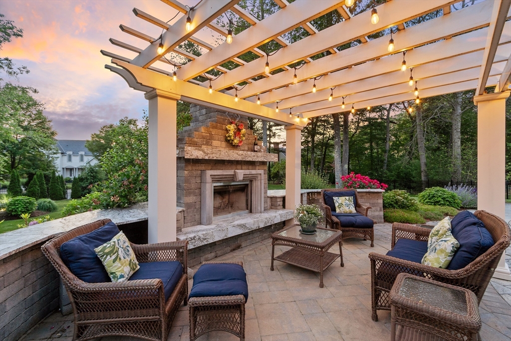 98 Fox Run Road Bolton, MA 01740 - Photo 40 of 42 a patio with patio couch and a fireplace
