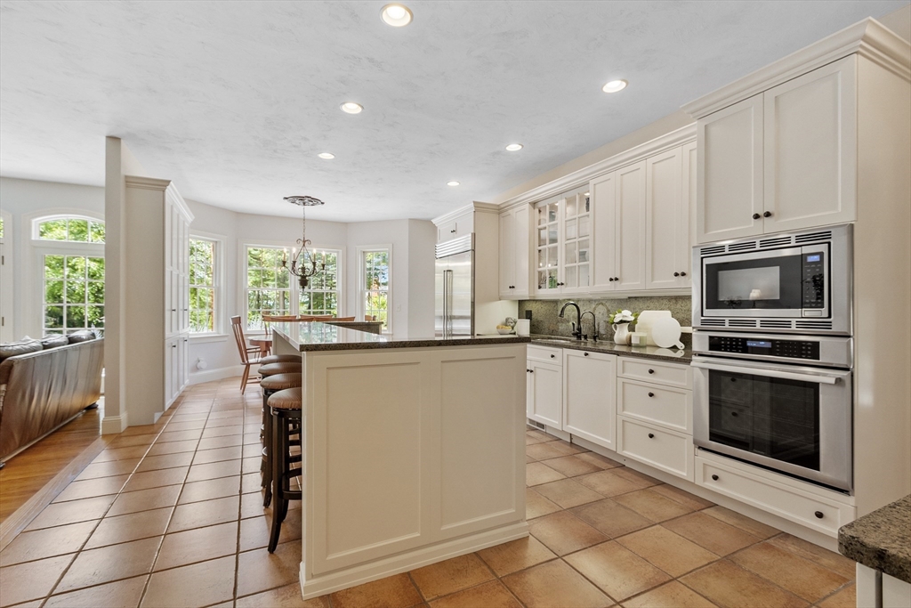 98 Fox Run Road Bolton, MA 01740 - Photo 4 of 42 a kitchen with granite countertop white cabinets appliances and a counter top space
