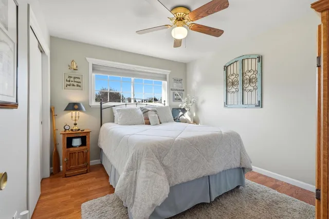 a living room with a bed furniture and a flat screen tv