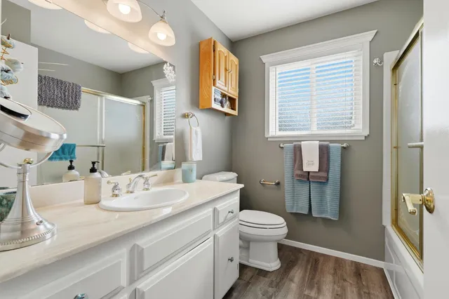 a bathroom with a toilet sink and shower