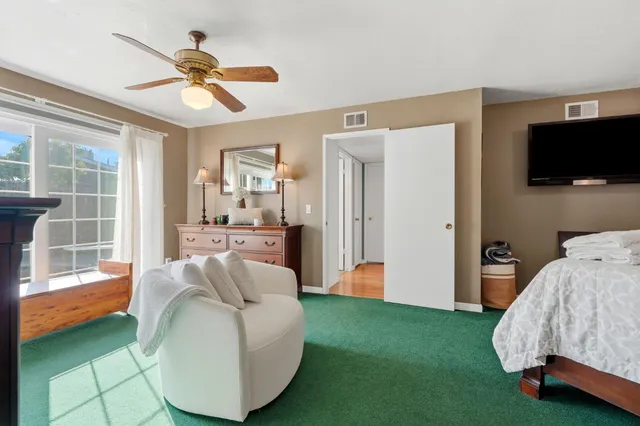 a bedroom with furniture and a fireplace