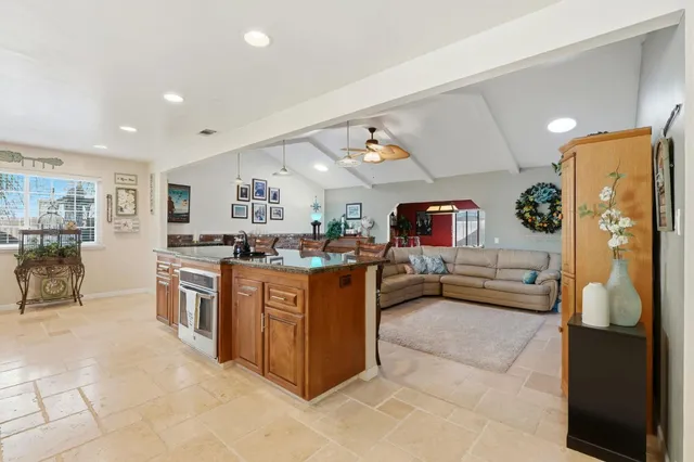 a living room with furniture a flat screen tv and a large window