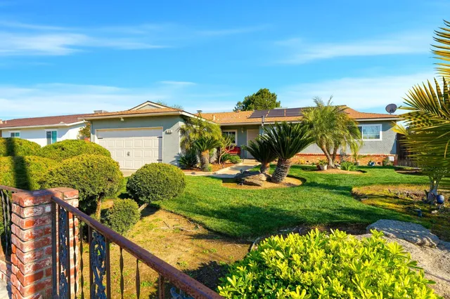 a front view of house with yard and green space