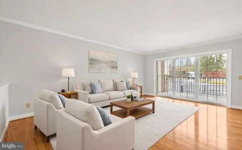 a living room with furniture and a large window with outer view