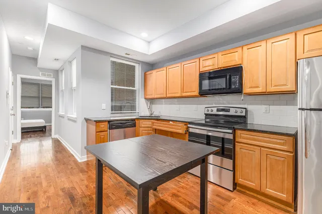 a kitchen with stainless steel appliances a stove a sink dishwasher and microwave