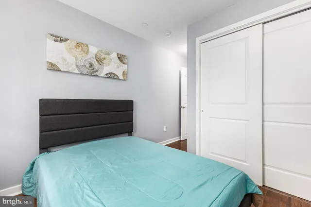 a bedroom with a bed and cabinets