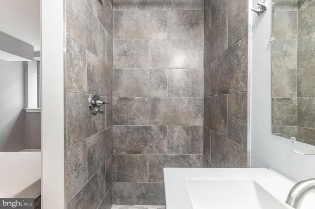a bathroom with a bathtub and shower