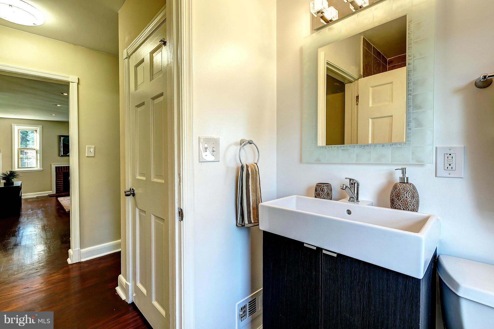 3023 Ridge Road Baltimore, MD 21244 - Photo 12 of 30 a bathroom with a sink and a mirror