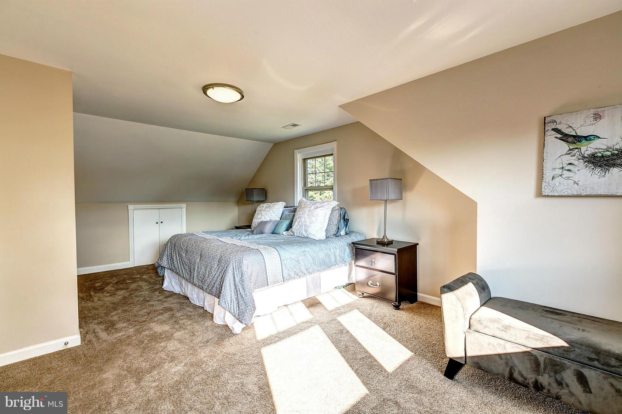 3023 Ridge Road Baltimore, MD 21244 - Photo 15 of 30 a bedroom with a bed and a chair