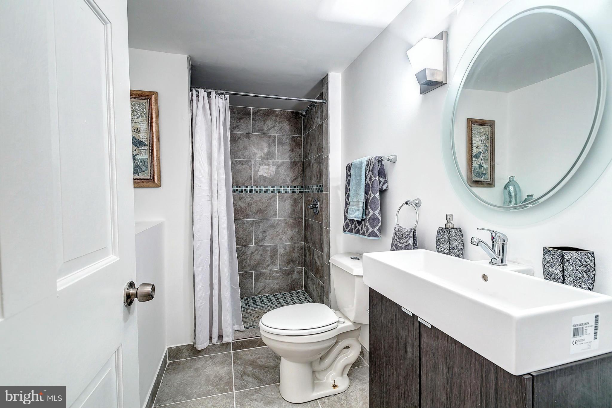 3023 Ridge Road Baltimore, MD 21244 - Photo 23 of 30 a bathroom with a sink toilet and shower