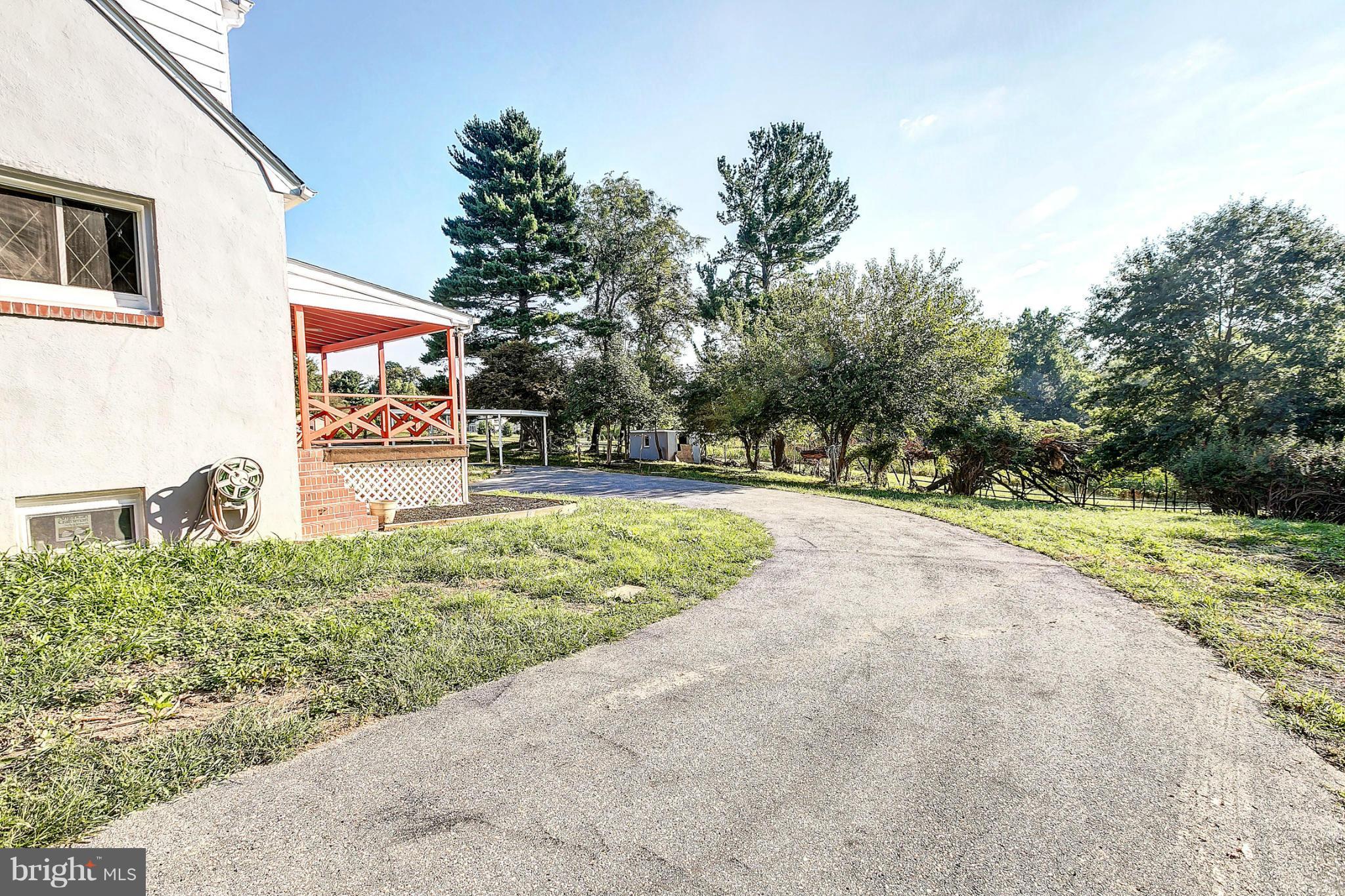 3023 Ridge Road Baltimore, MD 21244 - Photo 26 of 30 a pathway of a house and a yard with fountain