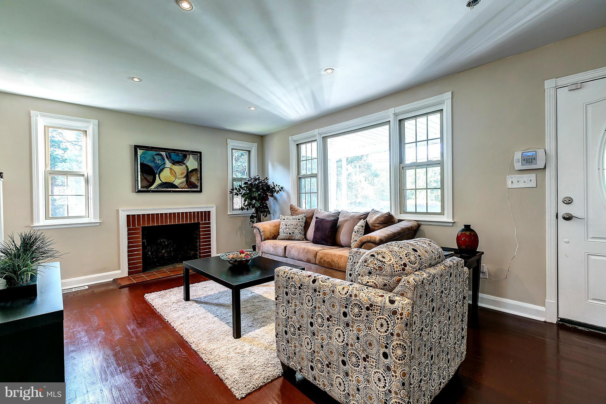 3023 Ridge Road Baltimore, MD 21244 - Photo 3 of 30 a living room with furniture a fireplace and a window