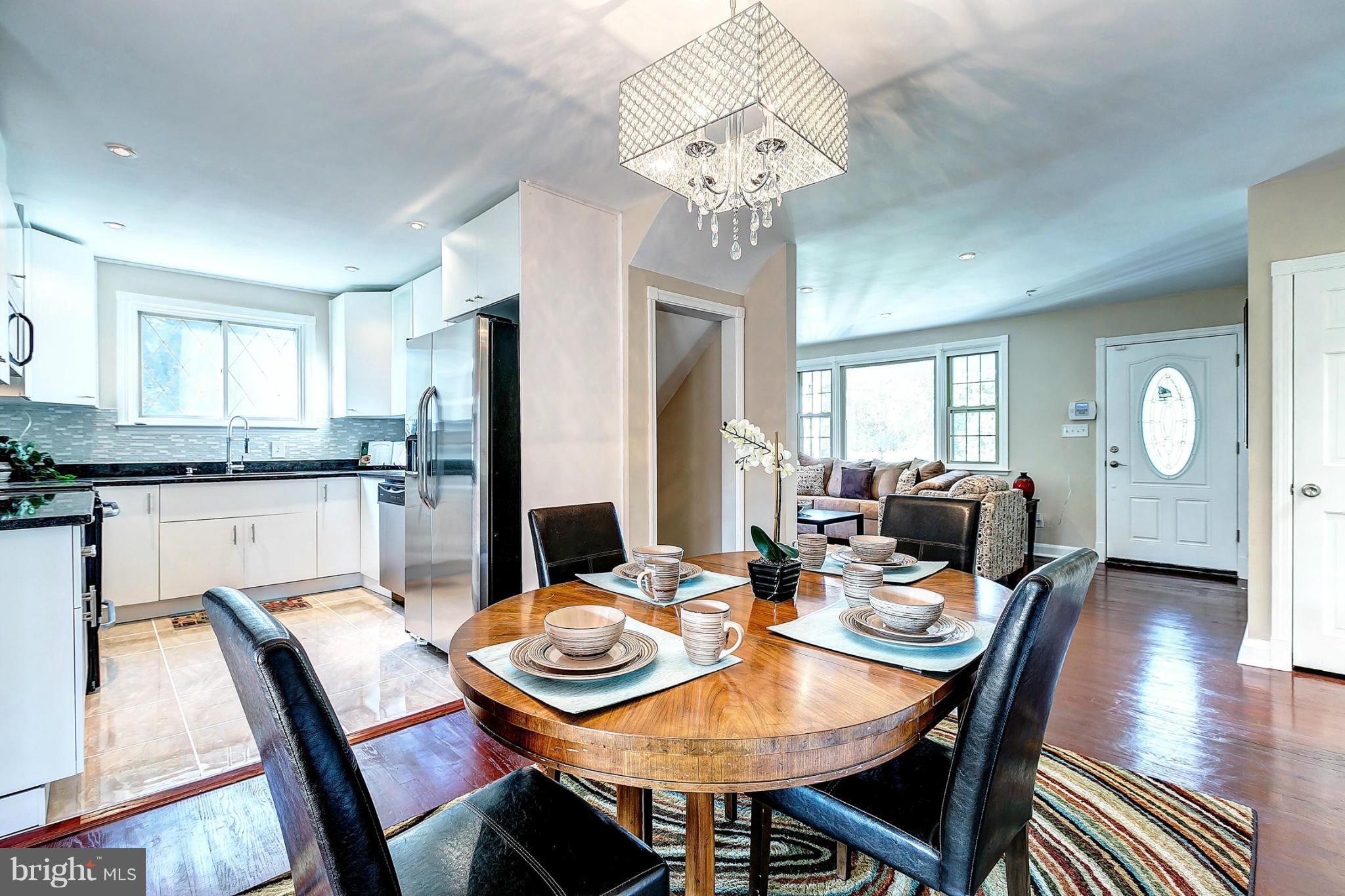 3023 Ridge Road Baltimore, MD 21244 - Photo 8 of 30 a view of a dining room with furniture a chandelier and wooden floor
