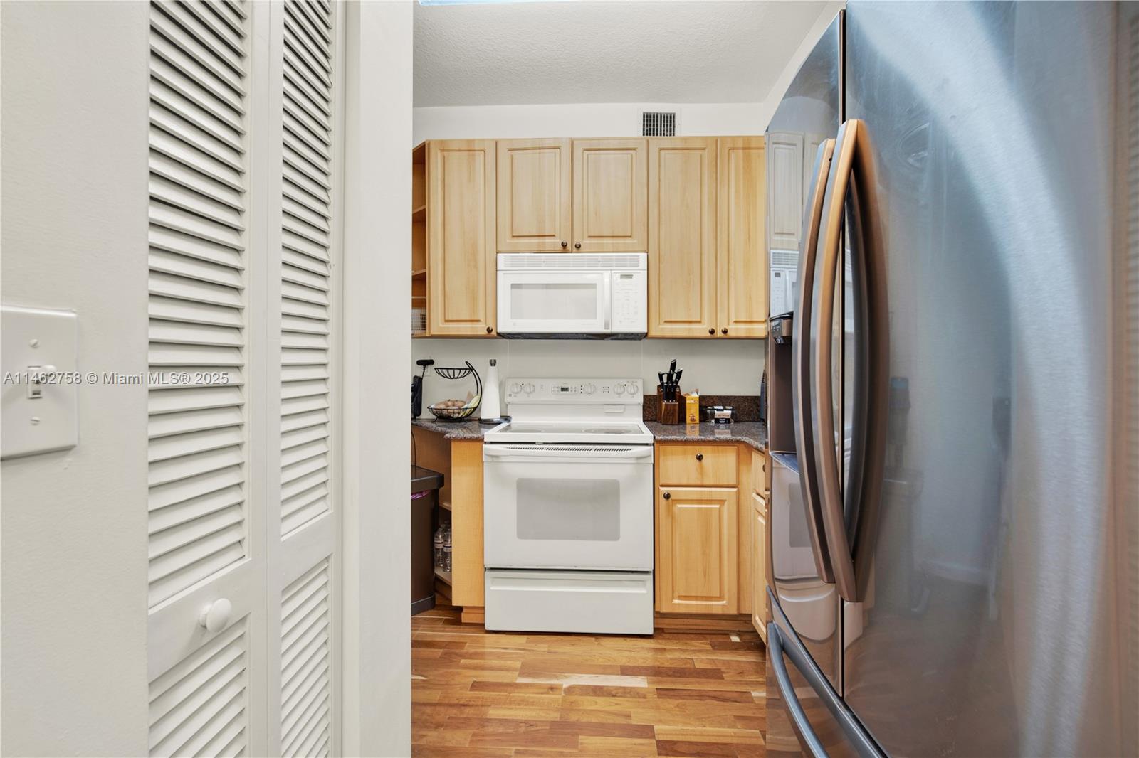 1 Century Lane, Unit 209 Miami Beach, FL 33139 - Photo 21 of 66 a kitchen with a refrigerator and a sink