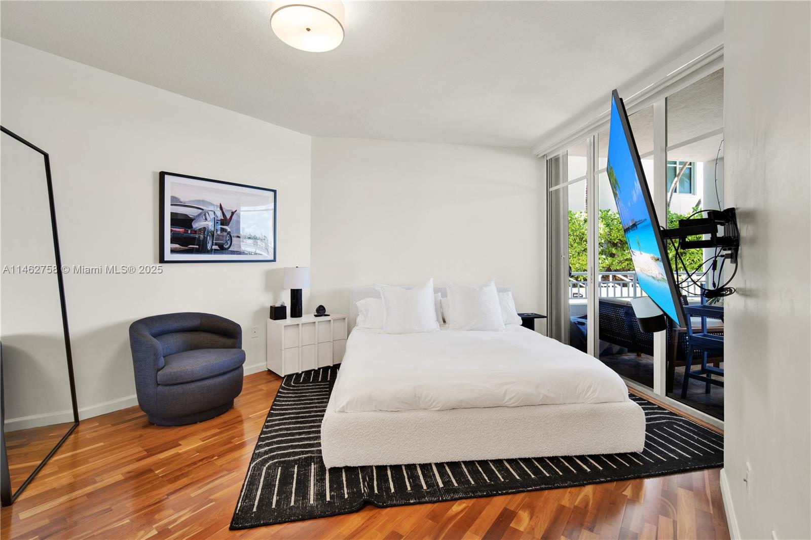 1 Century Lane, Unit 209 Miami Beach, FL 33139 - Photo 27 of 66 a bedroom with a bed and a large mirror on the dresser