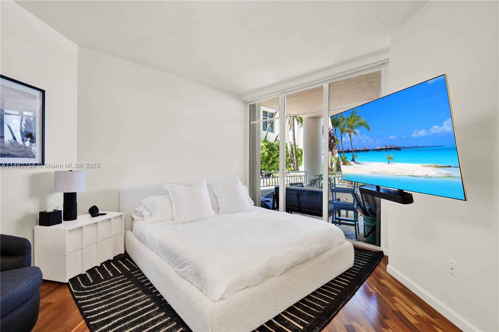 1 Century Lane, Unit 209 Miami Beach, FL 33139 - Photo 28 of 66 a bedroom with a bed and large windows