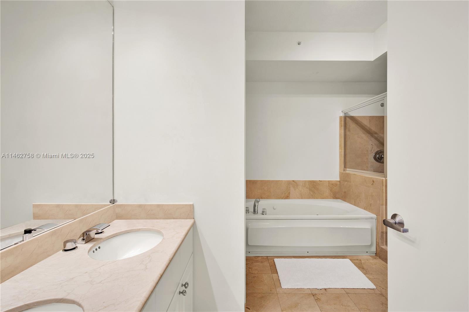 1 Century Lane, Unit 209 Miami Beach, FL 33139 - Photo 29 of 66 a bathroom with a tub sink and mirror