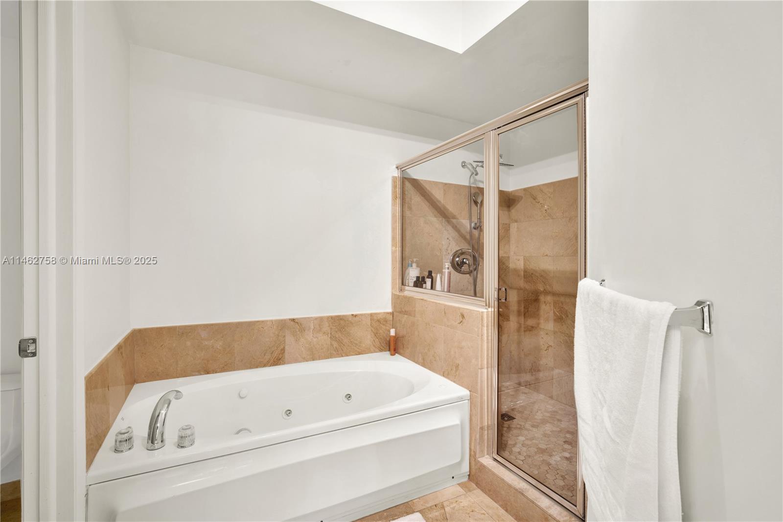 1 Century Lane, Unit 209 Miami Beach, FL 33139 - Photo 31 of 66 a bathroom with a tub and shower