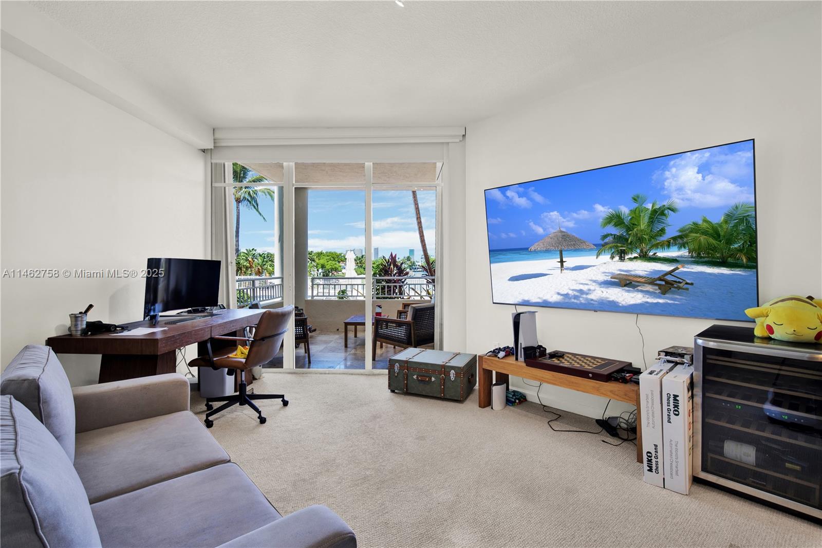 1 Century Lane, Unit 209 Miami Beach, FL 33139 - Photo 35 of 66 a living room with furniture flat screen tv and a large window