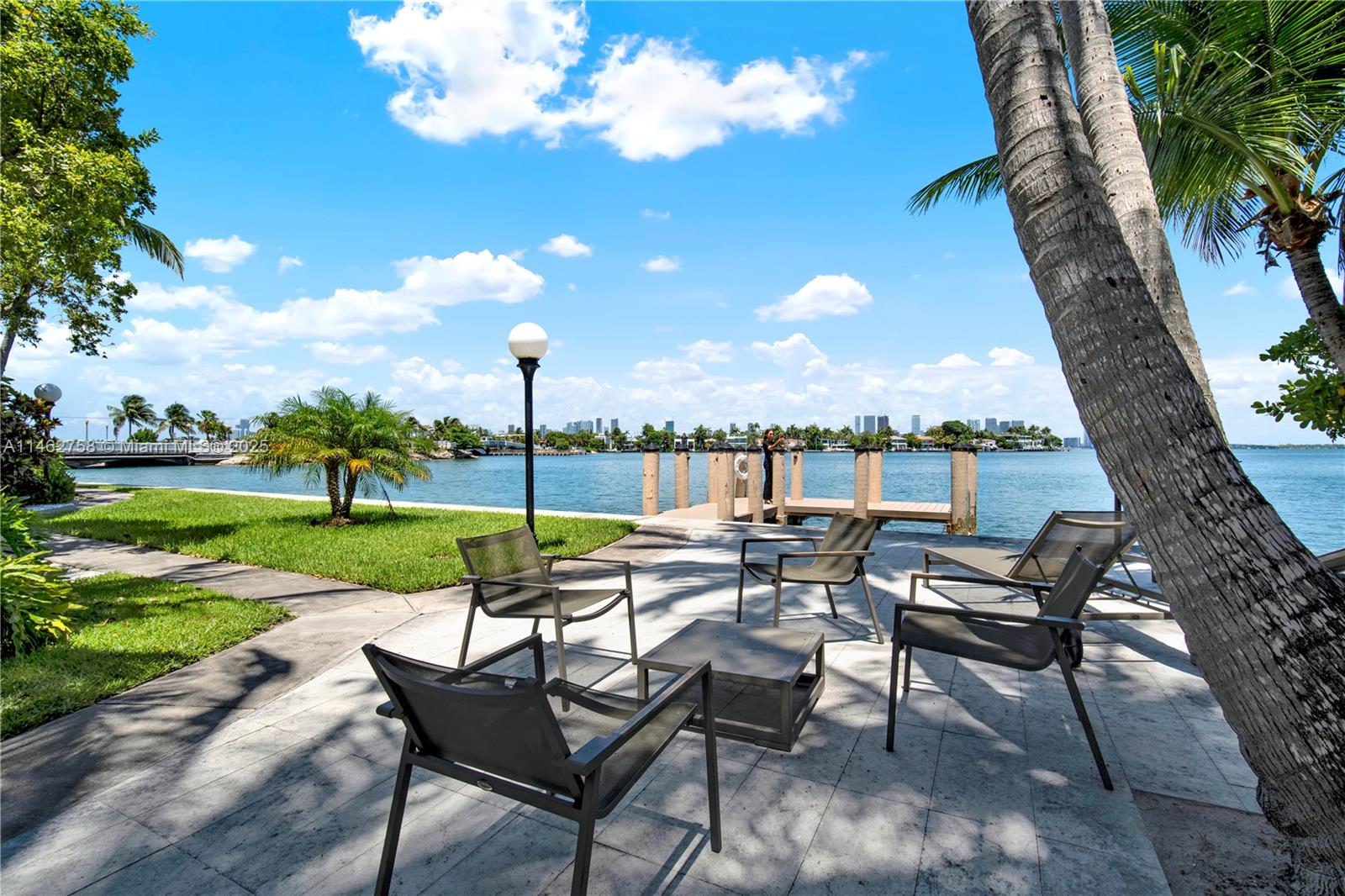 1 Century Lane, Unit 209 Miami Beach, FL 33139 - Photo 47 of 66 a view of a garden with a table and chairs under an umbrella
