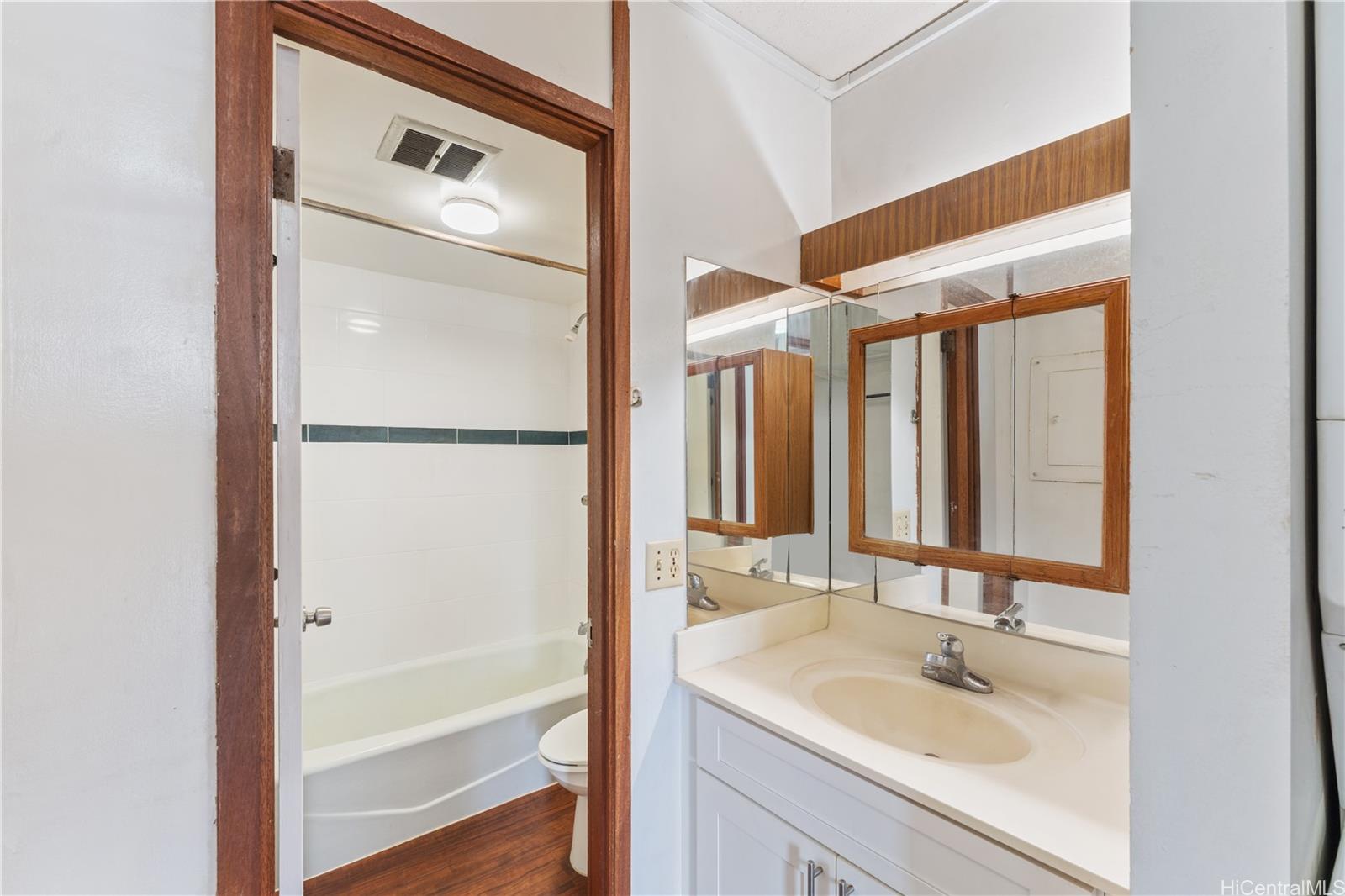 1505 Alexander Street, Unit 1205 Honolulu, HI 96822 - Photo 14 of 25 a bathroom with a sink and a large mirror