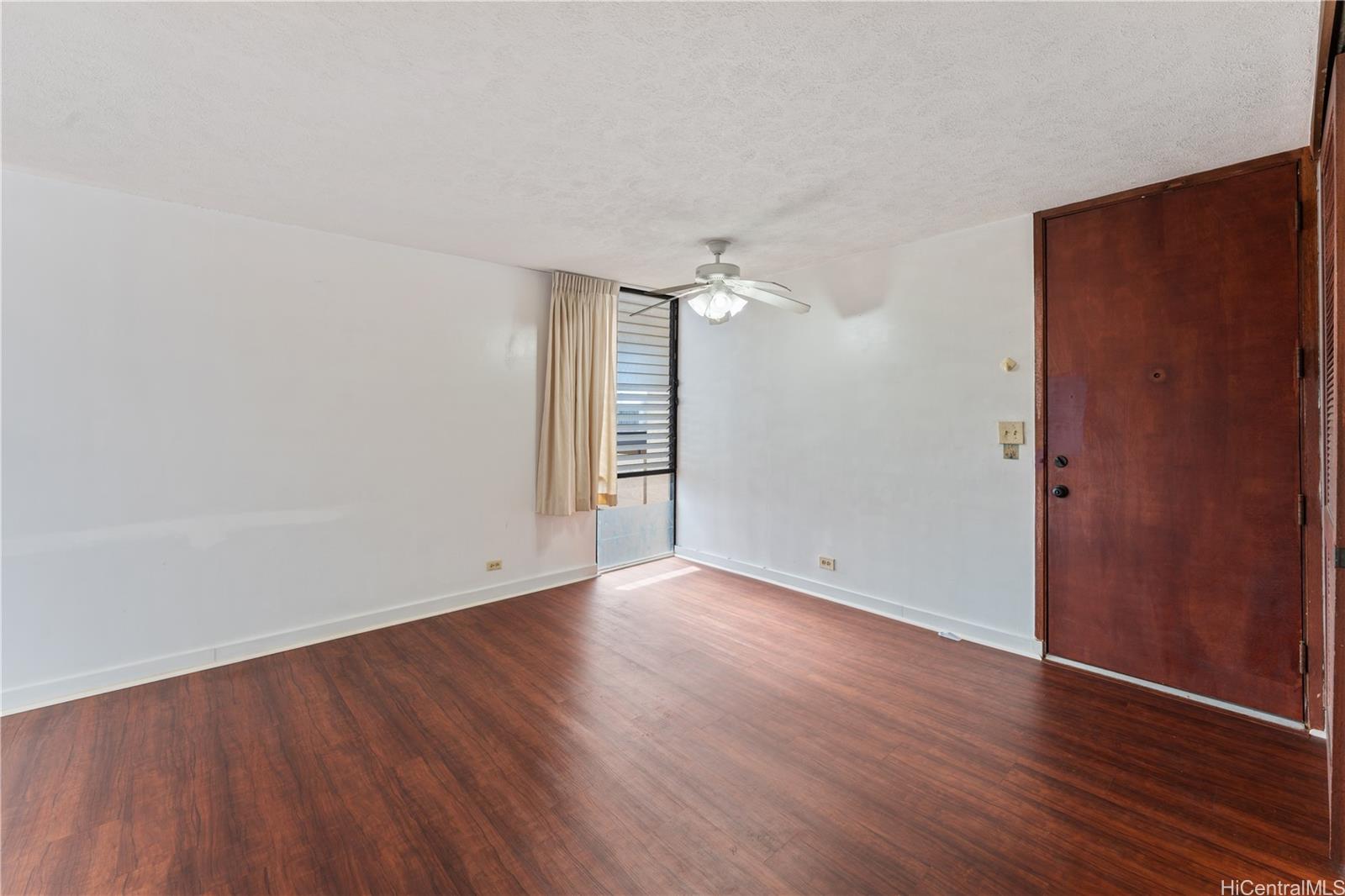 1505 Alexander Street, Unit 1205 Honolulu, HI 96822 - Photo 15 of 25 an empty room with wooden floor and windows