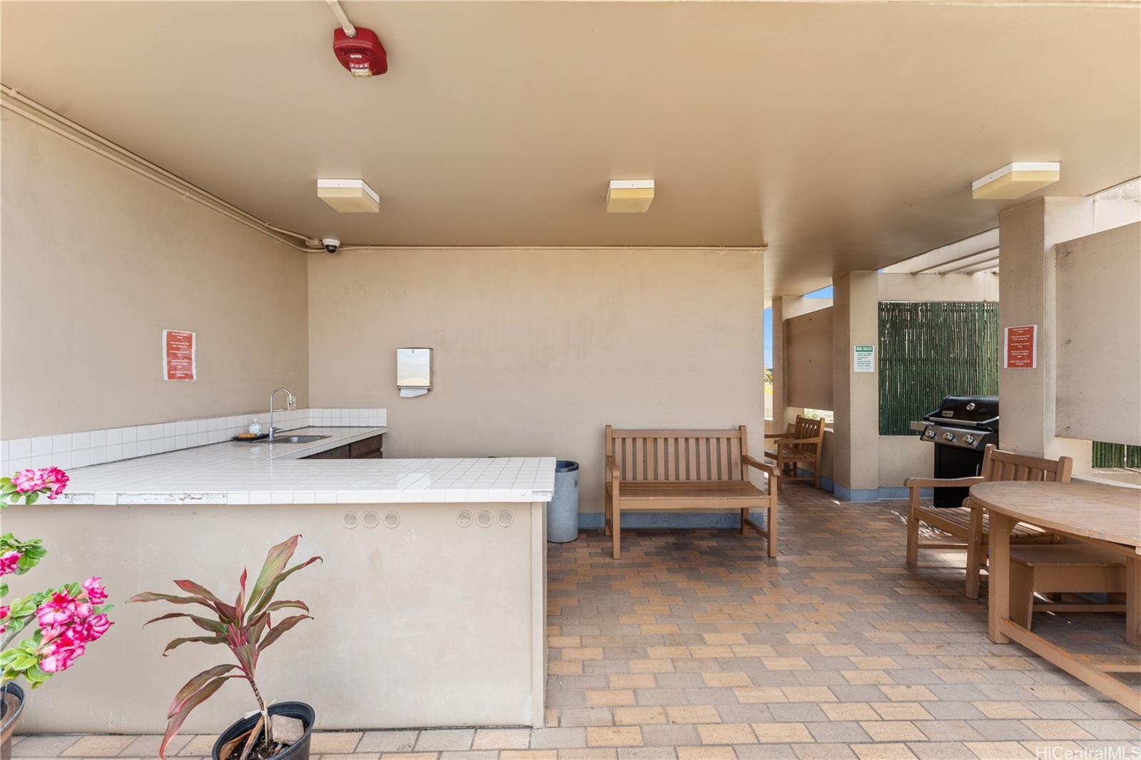 1505 Alexander Street, Unit 1205 Honolulu, HI 96822 - Photo 22 of 25 a room with a table and chairs