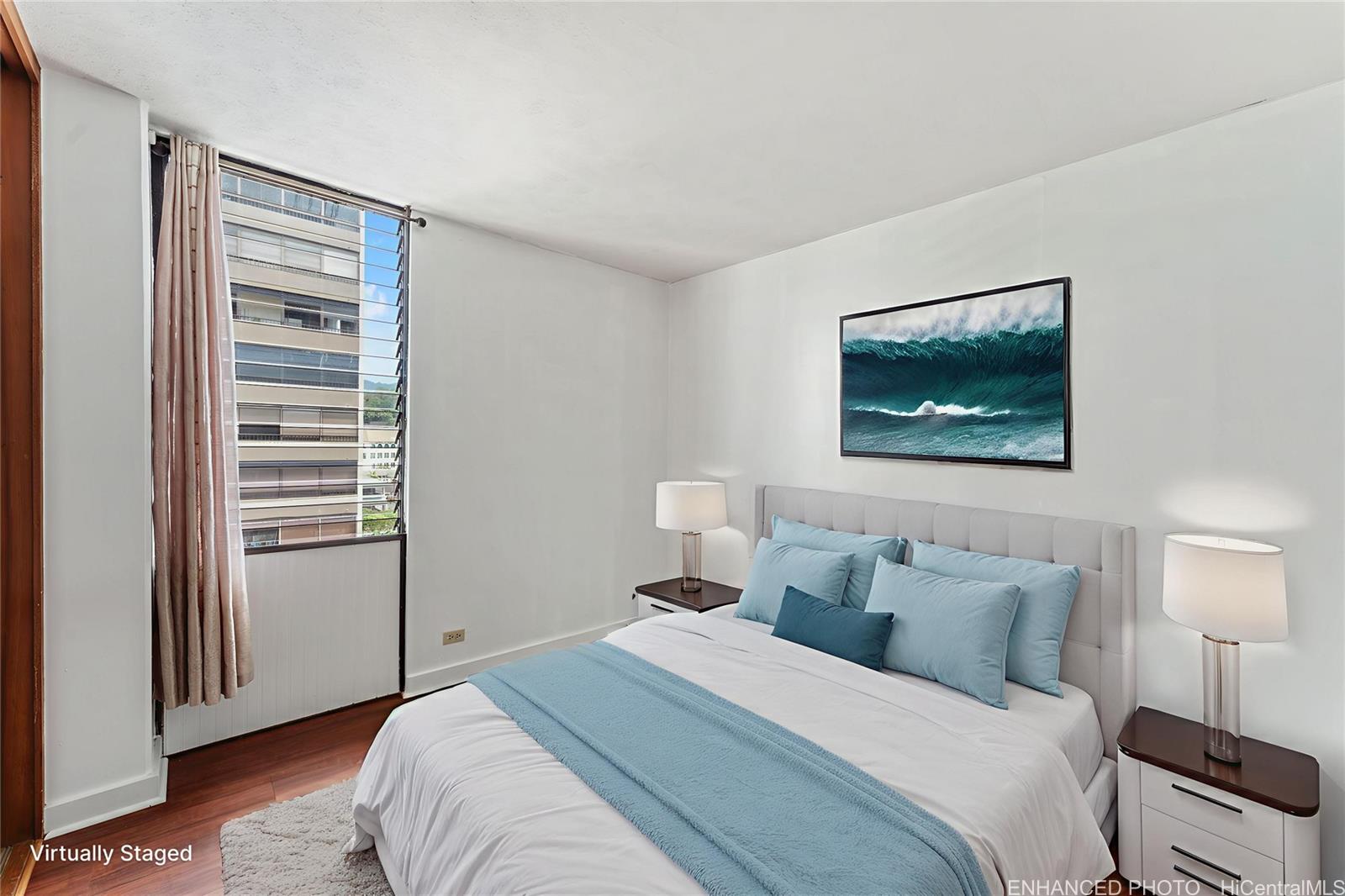 1505 Alexander Street, Unit 1205 Honolulu, HI 96822 - Photo 9 of 25 a bedroom with a bed and a night stand