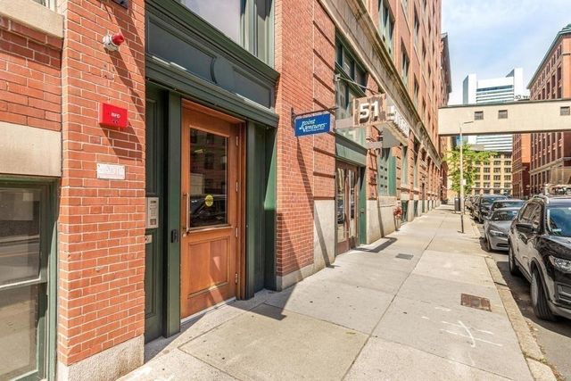 a view of a brick building with many windows