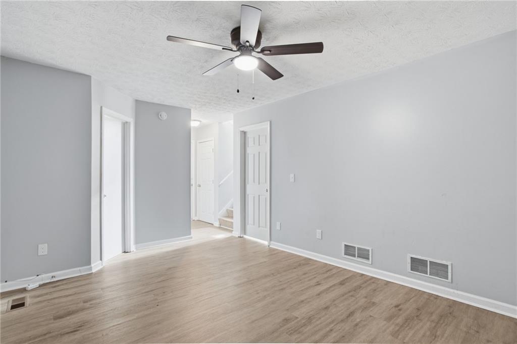 5855 Crescent Ridge Court Lithonia, GA 30058 - Photo 24 of 46 an empty room with wooden floor ceiling fan and window