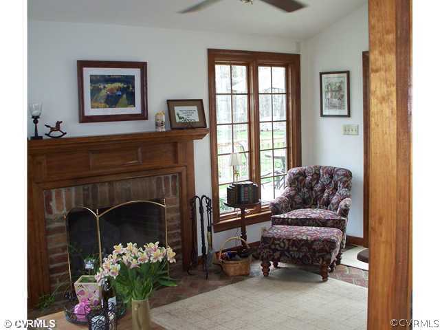 3021 East Brigstock Road Midlothian, VA 23113 - Photo 8 of 12 a living room with furniture and a fireplace