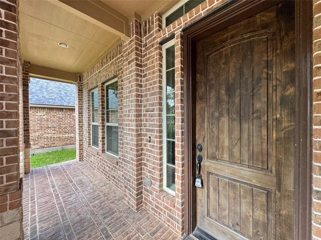 a view of a porch with a door and a wooden door